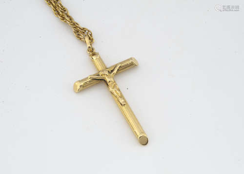 An 18ct gold crucifix pendant, on a 9ct gold double oval linked chain, 27cm together, total