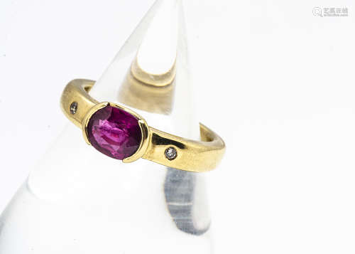 A contemporary 18ct gold ruby and diamond dress ring, the oval mixed cut ruby in tension collar