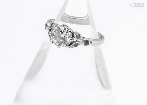 An old cut diamond solitaire platinum set engagement ring, with blue topaz floral set shoulders,