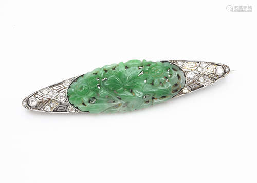 An Art Deco diamond, jade, platinum and 18ct gold brooch, the central Chinese carved green jade oval