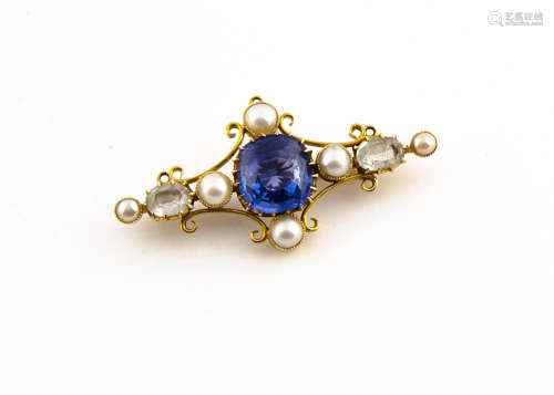 A gold synthetic sapphire and seed pearl bar brooch, the central blue claw set sapphire in a