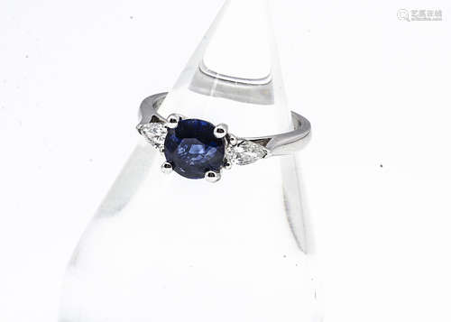 A three stone 18ct white gold sapphire and diamond ring, circular mixed cut in four claw setting