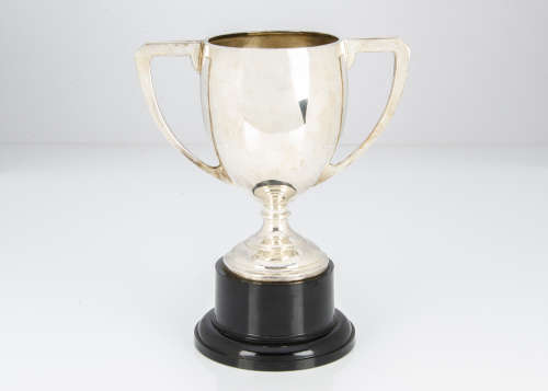 A George V period silver twin handled trophy cup, 10ozt, on black Bakelite style base, not engraved,