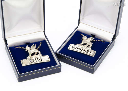 A 1990s pair of silver decanter labels from JHC, one for Gin, the other Whiskey, both with griffins,