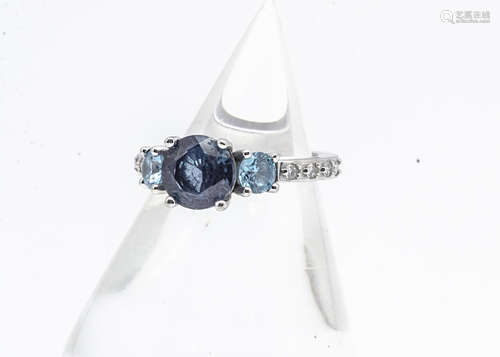 A synthetic colour change alexandrite, topaz and diamond American dress ring, the central mauve claw