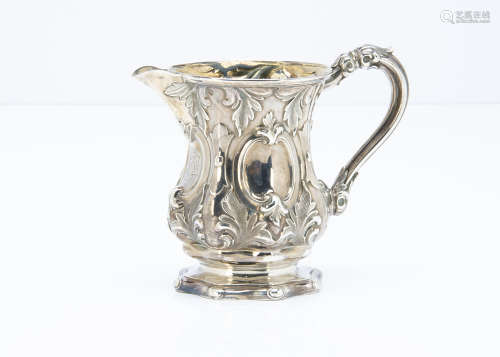 A Victorian white metal jug, similar to a Christening tankard with raised designs and gilt interior,