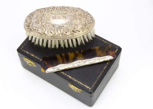 A cased 1960s silver mounted comb and clothes brush set