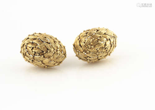 A pair of continental yellow metal clip earrings, of oval bombe shape with stylised engraved leaf