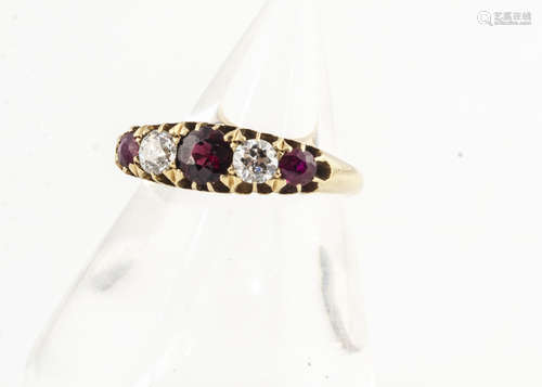 An 18ct gold ruby and diamond five stone ring, the three circular cut rubies with two old cut