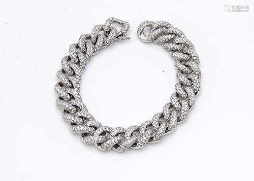 A continental white gold and diamond encrusted curb linked bracelet, the diamond links each