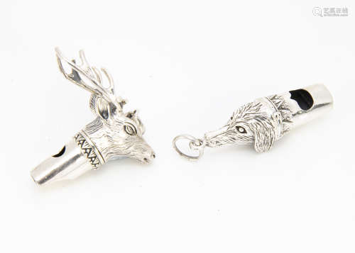 Two modern silver dog whistles, one in the form of a dogs head, the other with stags head (2)