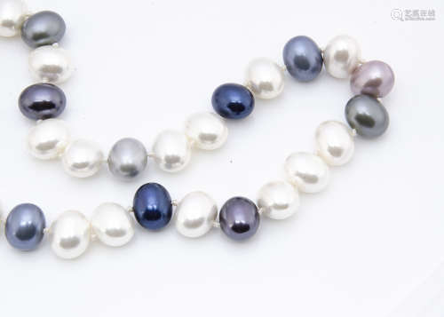 A diamond and cultured pearl necklace, the diamond sphere clasp supporting a knotted strung string