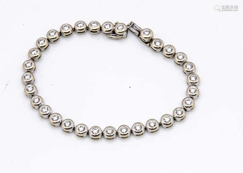 An 18ct white gold and diamond tennis bracelet, the thirty five brilliant cuts in rubbed over