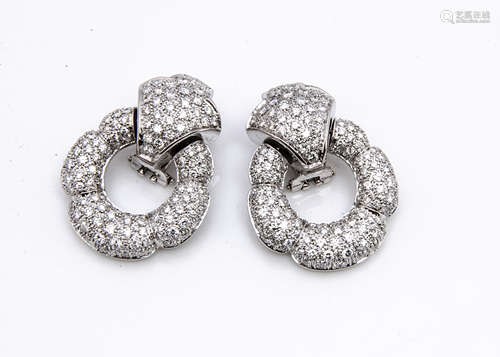 A pair of continental 18ct gold diamond encrusted clip earrings, the hinged stylised flower head