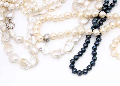 Two large strings of Baroque pearls, one with silver heart clasp, the other with a circular snap,