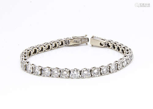 An 18ct gold diamond tennis bracelet, the claw set brilliant cuts united by a box and tongue