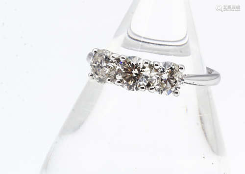 An 18ct white gold three stone diamond ring, the brilliant cuts in claw settings all in white metal,