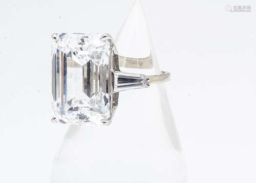 A continental 10k gold synthetic moissanite dress ring, the baguette cut stone in four claw