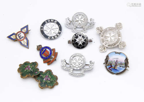A small collection of 20th Century military souvenir and St Johns badges, including an enamel