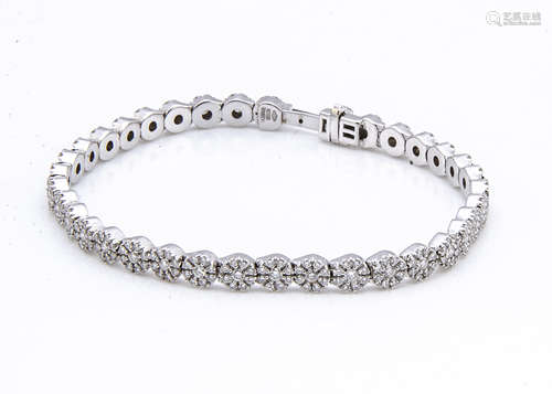 An 18ct white gold diamond bracelet, the circular flower head links set with brilliant cut diamonds,