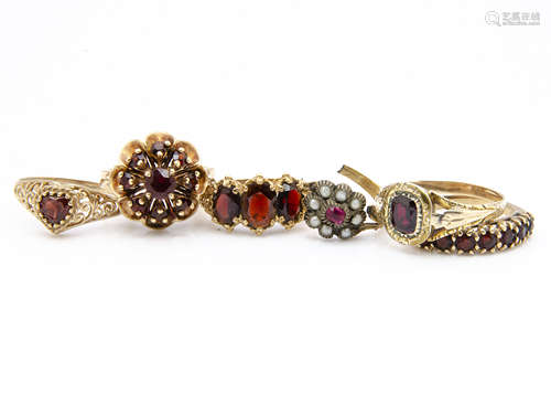 A 19th Century garnet ring, the cushion cut stone within a leaf and scroll mount, ring size T,