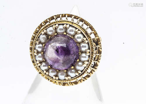 A continental amethyst and seed pearl yellow metal dress ring, the circular cabochon amethyst