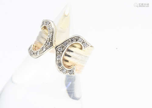 A Cartier style three colour gold dress ring, set with eight cut diamonds, ring size M, 6.2g