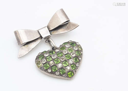 A sterling silver marked paste set heart and bow brooch, the chequered board green and colourless