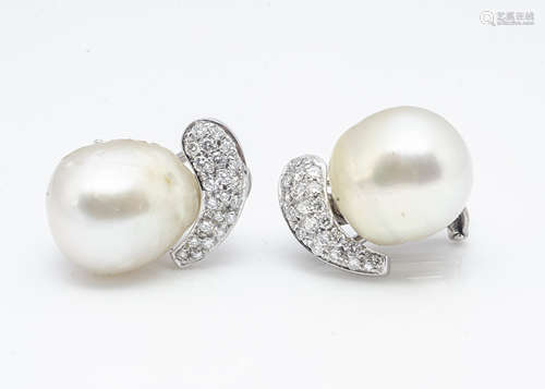 A pair of diamond and baroque pearl ear clips, the barrel shaped pearls set with a diamond pave