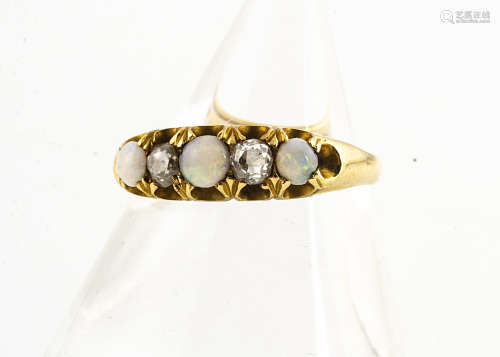 An 18ct gold opal and diamond five stone dress ring, the three cabochon white precious opals