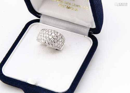 A continental white 18ct gold diamond bombe shaped ring, brilliant cuts in raised pave setting,