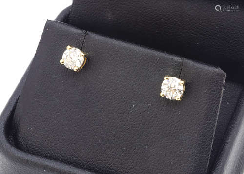 A pair of stud diamond earrings, in yellow metal claw mounts, posts marked 750, diamond weight 1.