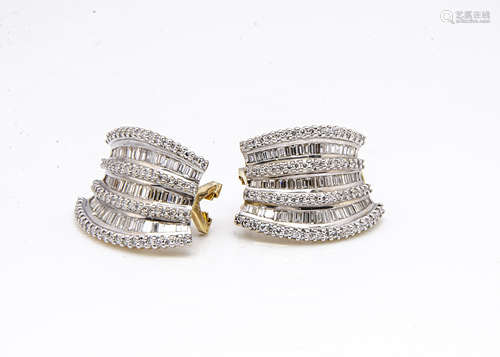 A pair of continental 18ct gold diamond ear clips of curved design, set with baguettes and brilliant