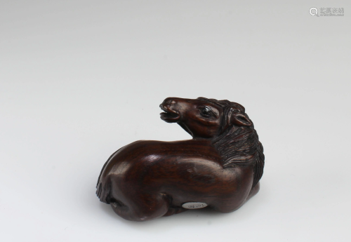 A Carved Wooden Horse Figurine