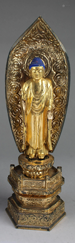 A Carved Wooden Standing Buddha Statue