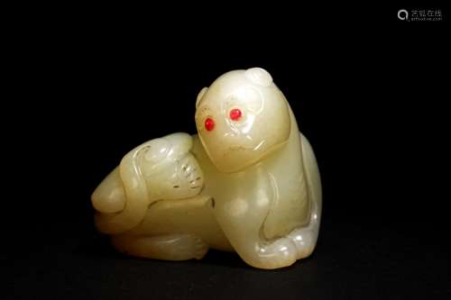A CELADON JADE CARVING OF MYTHICAL BEAST