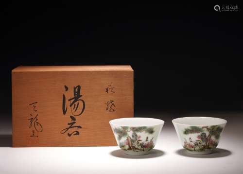 A PAIR OF FAMILLE ROSE 'PINES AND CRANES' INSCRIBED CUPS