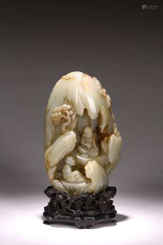 A WHITE JADE CARVED 'LUOHAN' GROTTO WITH STAND