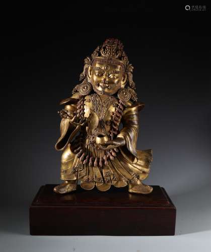 A LARGE GILT BRONZE FIGURE OF MAHAKALA WITH STAND