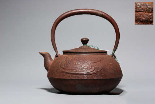 AN IRON POT CARVED WITH FLOWER PATTERN