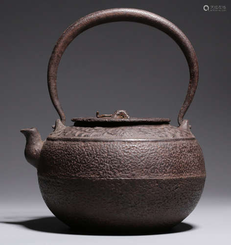 AN IRON POT CARVED WITH FLOWER PATTERN