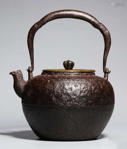 AN IRON POT WITH COPPER COVER