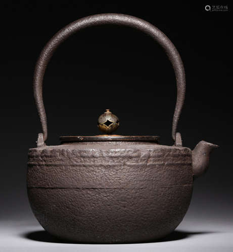 AN IRON POT WITH COPPER COVER