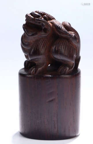 A RED WOOD SEAL SHAPED WITH BEAST
