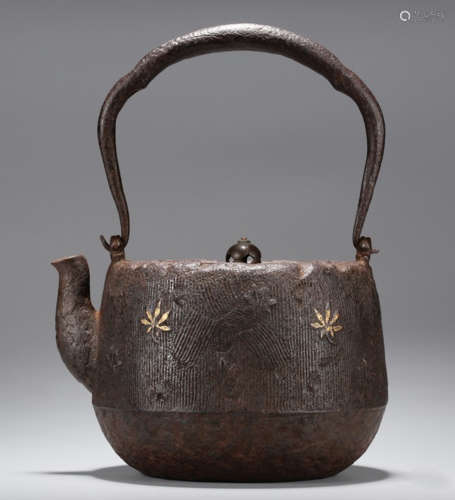 AN IRON POT CARVED WITH LEAVES