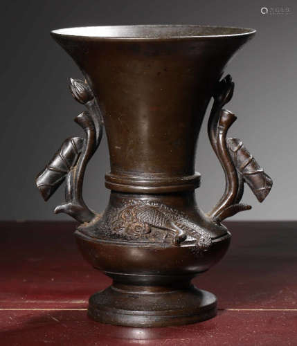 A COPPER VASE WITH FLOWER EARS
