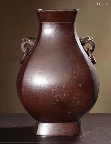 A COPPER VASE WITH BEAST ERAS