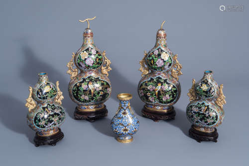 Two pairs of Chinese cloisonnŽ double gourd vases on wooden stands and a cloisonnŽ vase with floral