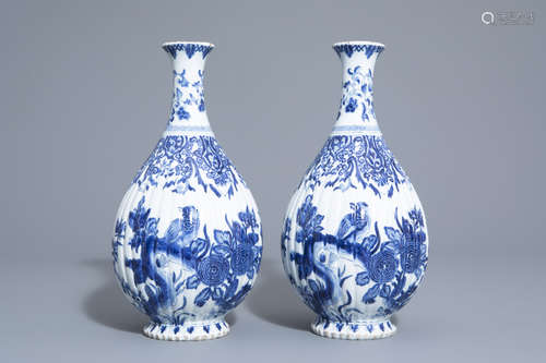 A pair of blue and white Delft style gadrooned bottle vases with birds among flower branches, Samson