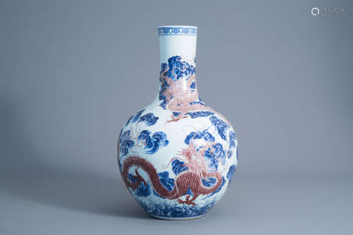 A large Chinese blue, white and copper red bottle shaped 'dragon' vase, Qianlong mark, 19th/20th C.